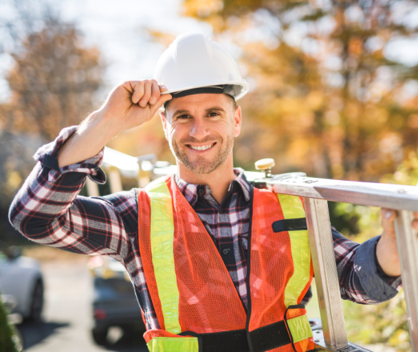 Best Inspector LA technician tipping hard hat while holding ladder during inspection