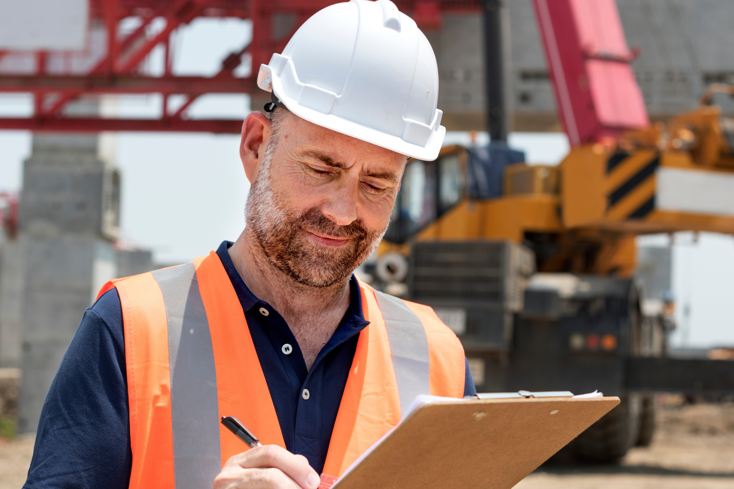 Inspector writing notes at commercial construction site
